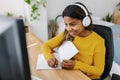 Smiling young african american student woman in headphones studying online Royalty Free Stock Photo