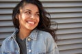 Smiling young African American teen girl looking away laughing, headshot.