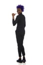 Happy Young Black Woman Is Standing And Pointing Behind Herself With Thumb. Rear View Royalty Free Stock Photo