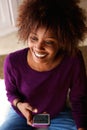 Smiling young african american woman with cell phone Royalty Free Stock Photo