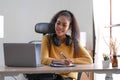 Smiling young African American woman in headphones distracted from computer work look in distance dreaming. Happy biracial female Royalty Free Stock Photo