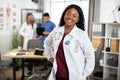 African American woman nurse standing in bright modern hospital meeting room Royalty Free Stock Photo