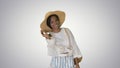 Smiling young african american woman in a straw hat posing on gr Royalty Free Stock Photo