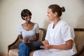 Smiling young African American woman visiting doctor in clinic Royalty Free Stock Photo