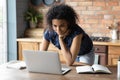 Smiling young african american woman working on computer at home. Royalty Free Stock Photo