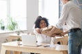 Smiling african employee taking pizza from courier, office food Royalty Free Stock Photo