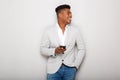 Smiling young african businessman with cellphone against gray background Royalty Free Stock Photo