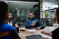 Smiling young African businessman talking with colleagues during an office meeting Royalty Free Stock Photo