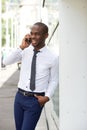 Smiling young african businessman talking with mobile phone in the city Royalty Free Stock Photo