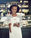 Smiling hostess offering a handshake in a cafe