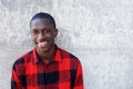 Smiling young african male model standing against wall Royalty Free Stock Photo