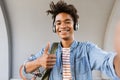 Smiling young african man with backpack outdoors Royalty Free Stock Photo