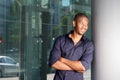 Smiling young african man leaning against wall in the city Royalty Free Stock Photo