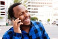 Smiling young african man talking on cellphone in the city Royalty Free Stock Photo