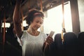 Smiling young African woman listening to music on a bus Royalty Free Stock Photo