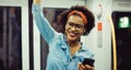 Smiling young African woman listening to music on the subway Royalty Free Stock Photo