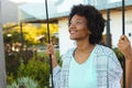 Smiling young afro african american woman looking away outside house Royalty Free Stock Photo