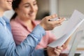 Smiling young arab lady and european man manager work with documents, planning finance business