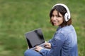 Smiling Young Arab Woman In Headphones Using Laptop With Blank Screen Outdoors Royalty Free Stock Photo