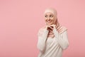 Smiling young arabian muslim girl in hijab light clothes posing isolated on pink background in studio. People religious Royalty Free Stock Photo