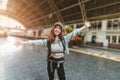 Smiling young Asian backpacker woman at train station. Ready for travel Royalty Free Stock Photo