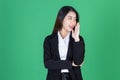 Smiling young Asian business woman with hand over ear listening an hearing to hearsay or rumor. Secret gossip concept Royalty Free Stock Photo