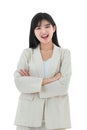 A portrait of happy young asian business woman wearing an ivory colored suit standing with confident and crossed arms on white Royalty Free Stock Photo