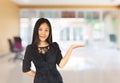 Smiling young Asian business women in black suit with hand presenting Royalty Free Stock Photo