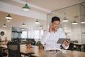 Asian businessman talking on his cellphone and holding a tablet Royalty Free Stock Photo