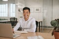 Smiling young Asian businessman working at his office desk Royalty Free Stock Photo