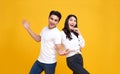 Smiling young Asian couple man and woman happy and amazed on yellow background.