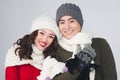 Smiling young asian couple wearing knitted warm scarf, over gray Royalty Free Stock Photo