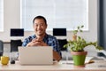 Smiling young Asian designer at work in a modern office Royalty Free Stock Photo