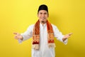 Smiling Young Asian Muslim man with welcome gesture during Ramadan Royalty Free Stock Photo