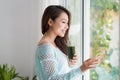 Smiling young asian woman drinking green fresh vegetable juice o Royalty Free Stock Photo