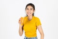 Smiling young Asian woman drinking orange juice over white isolated background. Lifestyle, Diet, Healthy and clean food concept Royalty Free Stock Photo