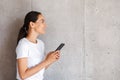 Smiling young asian woman holding mobile phone Royalty Free Stock Photo