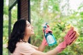 Smiling young asian woman housewife washes a window