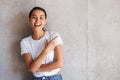 Smiling young asian woman pointing away at copy space Royalty Free Stock Photo