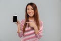 Smiling young asian woman showing display of phone Royalty Free Stock Photo