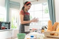 Smiling young asian woman work making sweet pie or pastry dough in kitchen Royalty Free Stock Photo