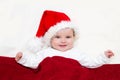 Smiling young baby in a Santa Claus hat Royalty Free Stock Photo