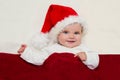 Smiling young baby in a Santa Claus hat Royalty Free Stock Photo