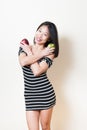 Smiling young beautiful asian woman shows two apples white background Royalty Free Stock Photo