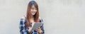 Smiling young beautiful asian women with book. Closeup brown head beautiful young woman pretty happy reading on concrete wall back Royalty Free Stock Photo