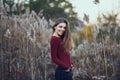 smiling young beautiful woman girl with messy blond long hair on windy day outdoor at sunset, looking in camera