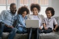 Happy african american family watching movie on computer. Royalty Free Stock Photo