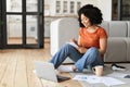 Smiling Young Black Female Student Using Laptop At Home And Taking Notes Royalty Free Stock Photo