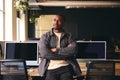 Smiling Young Black Male Standing In Office Looking Away From Camera With Arms Crossed Royalty Free Stock Photo