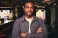 Smiling Young Black Male Standing In Office Looking At Camera With Arms Crossed Royalty Free Stock Photo